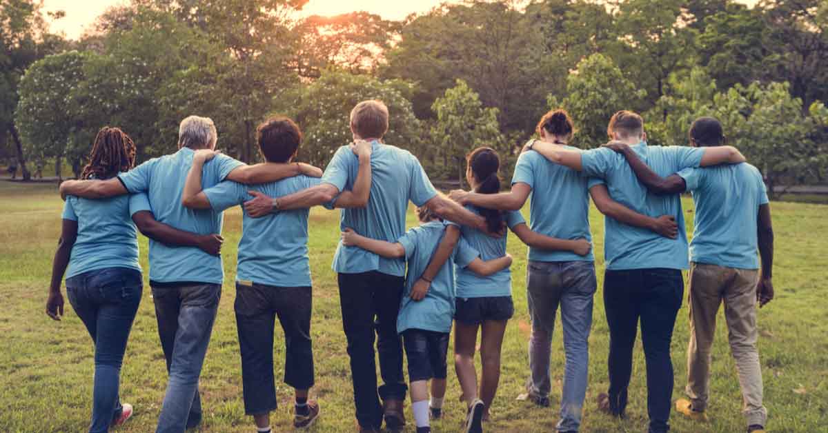 Image of community members standing arm in arm