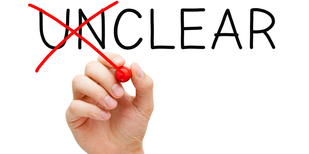 Decorative image of the word unclear, with a hand crossing out the UN with red ink.